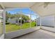 Screened lanai offers an outdoor living space with views of the lush, green backyard at 5414 Zinnia St, Leesburg, FL 34748