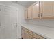 Mudroom features neutral cabinets and a door that leads to the outside at 5414 Zinnia St, Leesburg, FL 34748