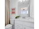 Bright bathroom with a clean, white vanity, modern fixtures, and a mirror reflecting natural light at 6033 Tree Crossing Ln, St Cloud, FL 34771