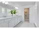 Bright bathroom features double vanity, quartz counters, and an entrance to a separate water closet at 6033 Tree Crossing Ln, St Cloud, FL 34771