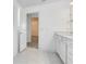 Bright bathroom showing vanity with quartz counters and an entrance to the walk-in closet at 6033 Tree Crossing Ln, St Cloud, FL 34771