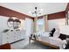 Decorated bedroom with a modern light fixture, race car decor, and closet at 6033 Tree Crossing Ln, St Cloud, FL 34771