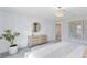 Calm bedroom with a dresser, side table, round mirror, and neutral tones at 6033 Tree Crossing Ln, St Cloud, FL 34771