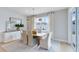 Modern dining room with neutral color palette and light hardwood flooring at 6033 Tree Crossing Ln, St Cloud, FL 34771