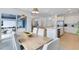 Bright dining area featuring modern lighting, kitchen access, and patio view creating an inviting atmosphere at 6033 Tree Crossing Ln, St Cloud, FL 34771