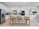 Modern kitchen boasts a spacious island, pendant lighting, and stainless steel appliances at 6033 Tree Crossing Ln, St Cloud, FL 34771