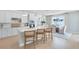 Bright eat-in kitchen features an island with seating, and stainless steel appliances at 6033 Tree Crossing Ln, St Cloud, FL 34771