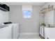 Well-organized laundry room with modern appliances and shelving for ample storage at 6033 Tree Crossing Ln, St Cloud, FL 34771