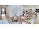 Inviting living room showcasing light wood floors and an open layout to the modern kitchen area at 6033 Tree Crossing Ln, St Cloud, FL 34771