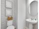 Modern powder room featuring stylish wallpaper, a round mirror, and a pedestal sink at 6033 Tree Crossing Ln, St Cloud, FL 34771