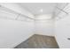 Empty walk-in closet with wall-mounted wire shelves and carpeted floor at 6033 Tree Crossing Ln, St Cloud, FL 34771