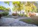 Landscaped backyard featuring brick paver walkways, mature trees, and flowering bushes at 613 Andrew St, Altamonte Springs, FL 32714