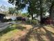 Spacious backyard with lush landscaping, a stone patio, and a privacy fence at 613 Andrew St, Altamonte Springs, FL 32714