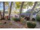 Landscaped backyard featuring brick paver walkways, mature trees, and flowering bushes at 613 Andrew St, Altamonte Springs, FL 32714