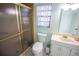 Clean bathroom with a glass-enclosed shower, toilet, vanity and sink at 613 Andrew St, Altamonte Springs, FL 32714