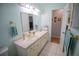 Bathroom featuring a mirror, vanity, and neutral tiling throughout at 613 Andrew St, Altamonte Springs, FL 32714