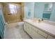 Bathroom featuring a vanity, mirror, and shower with gold trim at 613 Andrew St, Altamonte Springs, FL 32714
