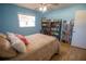 View of the bed and wood floors in bedroom with fan and storage at 613 Andrew St, Altamonte Springs, FL 32714
