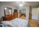 Bedroom featuring hardwood floors, dresser, ceiling fan, and mirrored closet, offering functionality and storage at 613 Andrew St, Altamonte Springs, FL 32714