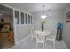 View of the dining area with white table set near a half wall feature at 613 Andrew St, Altamonte Springs, FL 32714