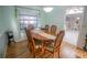 Bright dining room with a hardwood table, six chairs, and a large window at 613 Andrew St, Altamonte Springs, FL 32714