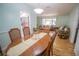 Bright dining room with a hardwood table, four chairs, and views into the kitchen and living room at 613 Andrew St, Altamonte Springs, FL 32714