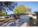 Charming single-story home with a two-car garage, brick accents, and mature trees at 613 Andrew St, Altamonte Springs, FL 32714