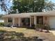 Cozy one-story home with a covered porch, manicured landscaping, and an attached two-car garage, ideal for suburban living at 613 Andrew St, Altamonte Springs, FL 32714