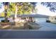 Charming single-story home with brick accents, a well-manicured lawn, mature trees, and an attached two-car garage at 613 Andrew St, Altamonte Springs, FL 32714