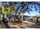 Charming single-story home with brick accents, a well-manicured lawn, mature trees, and an attached two-car garage at 613 Andrew St, Altamonte Springs, FL 32714