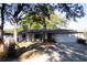 Charming single-story home with brick accents, a well-manicured lawn, mature trees, and an attached two-car garage at 613 Andrew St, Altamonte Springs, FL 32714