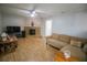 Cozy living room with wood laminate floors, a stone fireplace, neutral paint, and sliding glass doors for ample natural light at 613 Andrew St, Altamonte Springs, FL 32714