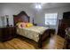 Comfortable bedroom with decorative wood trim bed frame and wood laminate flooring at 613 Andrew St, Altamonte Springs, FL 32714
