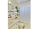 Bathroom featuring a vanity, a decorative mirror, and elegant white tiling with blue accents at 714 West Ct, Longwood, FL 32750