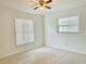 Well-lit bedroom with tile flooring, ceiling fan, and natural light from two windows at 714 West Ct, Longwood, FL 32750