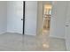 Bright bedroom featuring tile flooring and a glimpse of the ensuite bathroom at 714 West Ct, Longwood, FL 32750