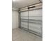 Spacious garage featuring tile flooring and a well-maintained door at 714 West Ct, Longwood, FL 32750