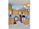 Open-concept kitchen features wooden cabinets, stainless steel appliances, and an eye-catching backsplash at 714 West Ct, Longwood, FL 32750