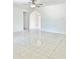 Open-concept living room features a ceiling fan, a glossy tile floor, and white paint at 714 West Ct, Longwood, FL 32750