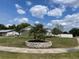 Lush green lawn featuring a small, circular garden bed with palm trees in the center at 714 West Ct, Longwood, FL 32750