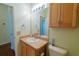 Bathroom featuring a white sink and a cabinet with a large mirror at 790 Blake Ln, The Villages, FL 32162