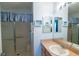 Bathroom with a glass shower, vanity with sink, and decorated with beach themed décor at 790 Blake Ln, The Villages, FL 32162