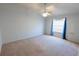 Spacious bedroom with a ceiling fan, neutral carpet, and large window at 790 Blake Ln, The Villages, FL 32162