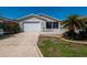 Charming one story home featuring attached one car garage and screened in porch, surrounded by a white picket fence at 790 Blake Ln, The Villages, FL 32162