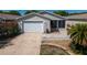Charming one story home featuring attached one car garage and screened in porch, surrounded by a white picket fence at 790 Blake Ln, The Villages, FL 32162