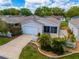 Aerial view of a well-maintained home with a landscaped front yard and a white picket fence at 790 Blake Ln, The Villages, FL 32162