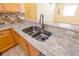 Close up of the kitchen sink with granite countertops and stainless steel faucet at 790 Blake Ln, The Villages, FL 32162