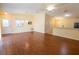 Bright living room with laminate wood floors and neutral walls, leading to a modern kitchen with stainless appliances at 790 Blake Ln, The Villages, FL 32162
