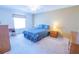 Comfortable bedroom with neutral walls, a plush carpet, and a cozy bed with decorative pillows at 8201 Se 169Th Palownia Loop, The Villages, FL 32162