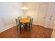 Cozy dining area with a round wooden table and comfortable chairs near a bright window at 8201 Se 169Th Palownia Loop, The Villages, FL 32162